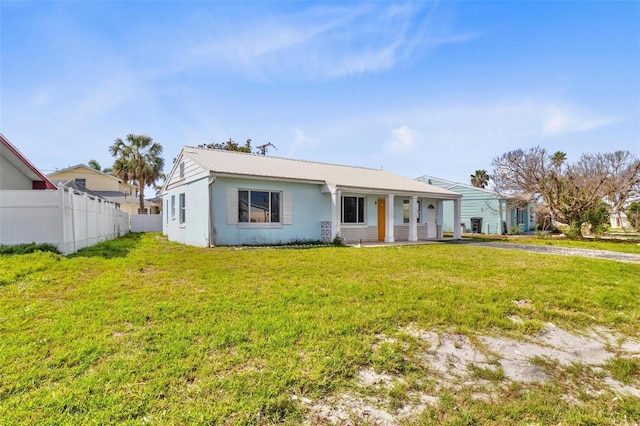 rear view of house featuring a yard