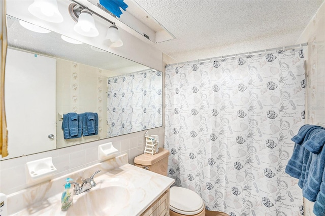 bathroom with tasteful backsplash, vanity, toilet, and a textured ceiling