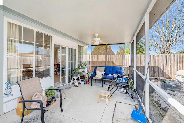 sunroom featuring ceiling fan