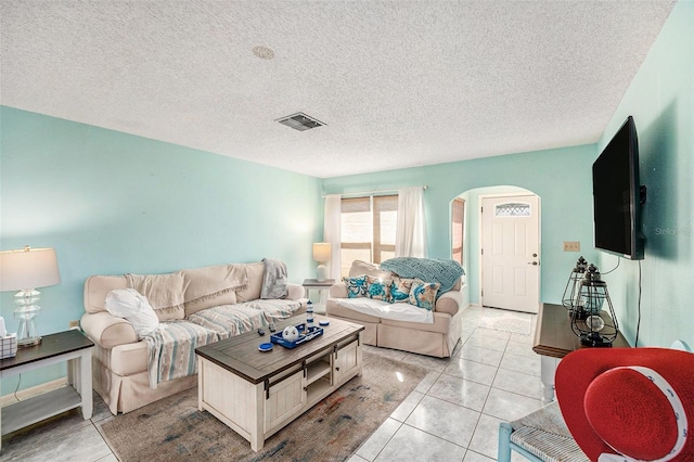 living room with light tile patterned floors and a textured ceiling