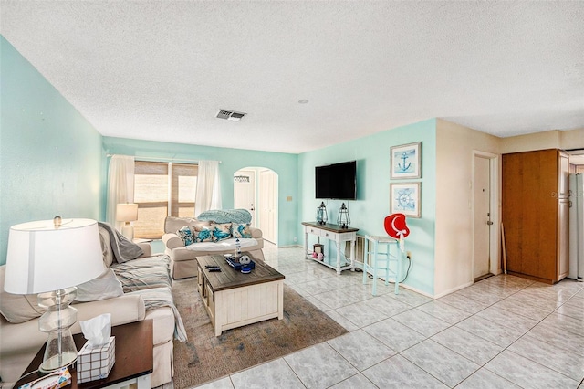 tiled living room with a textured ceiling