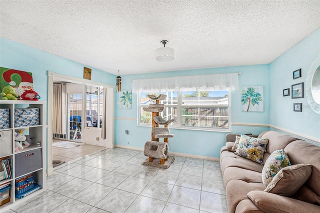 living area featuring light tile patterned floors and a textured ceiling