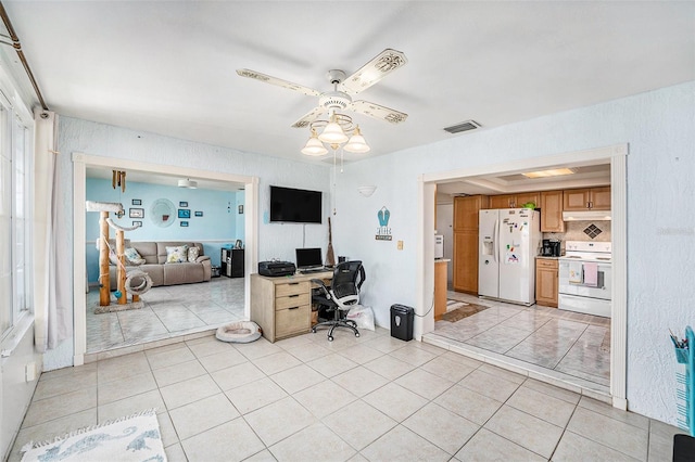 tiled office featuring ceiling fan