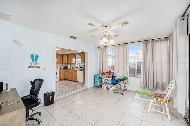 office featuring sink, light tile patterned floors, and ceiling fan