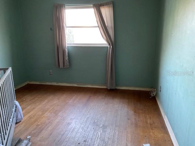 unfurnished room featuring light wood-style flooring and baseboards