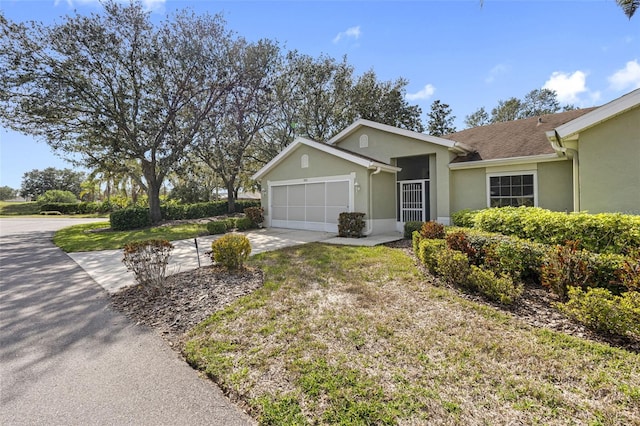 ranch-style house with a garage and a front yard