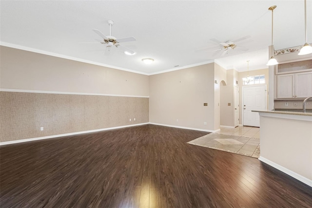 unfurnished living room featuring crown molding, light hardwood / wood-style floors, and ceiling fan