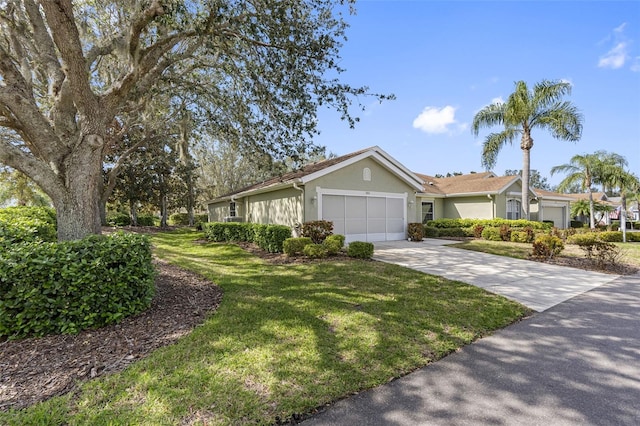 ranch-style house featuring a garage and a front lawn