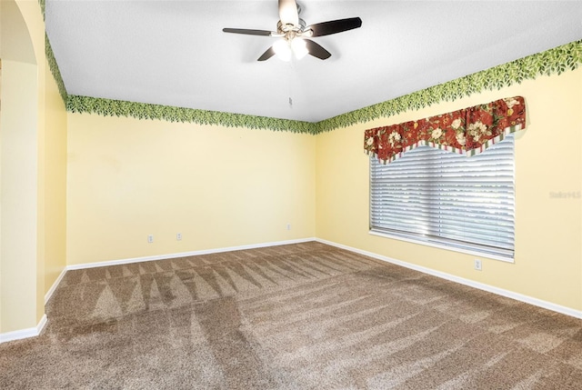 carpeted empty room featuring ceiling fan