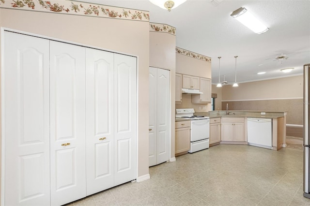 kitchen featuring sink, white appliances, decorative light fixtures, and a textured ceiling