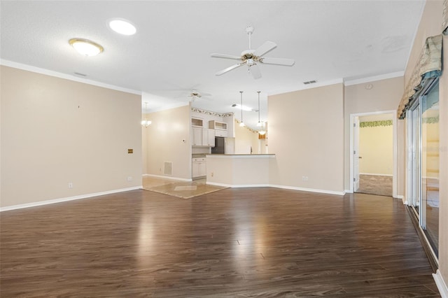 unfurnished living room featuring vaulted ceiling, dark hardwood / wood-style floors, ceiling fan, crown molding, and a textured ceiling