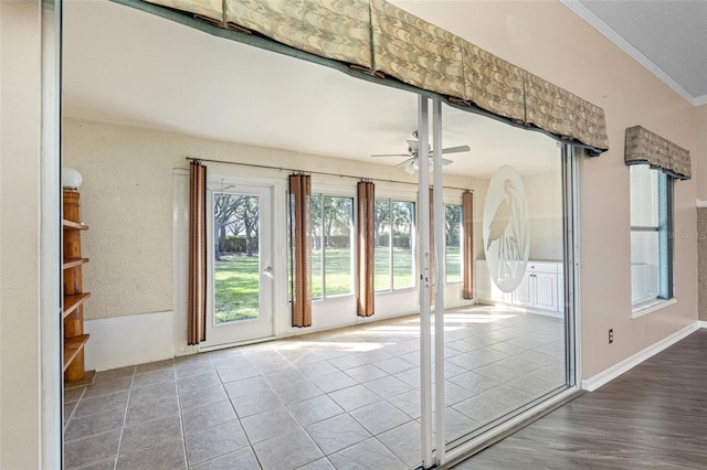 doorway to outside with tile patterned floors and ceiling fan