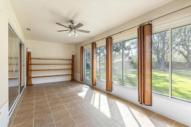 doorway to outside with tile patterned flooring and ceiling fan