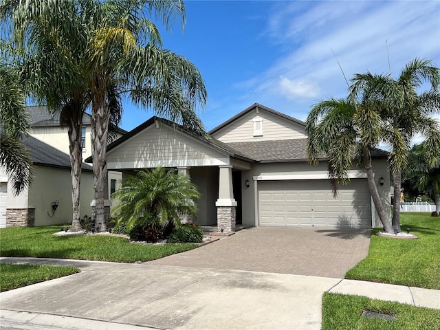 view of front of property featuring a garage and a front yard