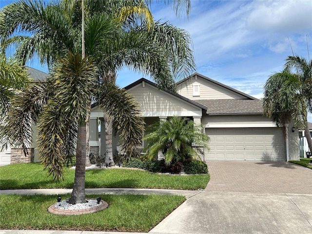 view of front of house with a garage and a front yard