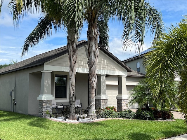 view of front facade with an attached garage, stone siding, and stucco siding