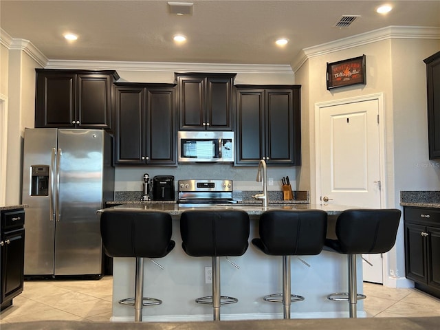 kitchen with stainless steel appliances, stone counters, a kitchen breakfast bar, and crown molding