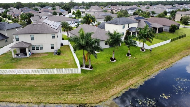 drone / aerial view featuring a water view and a residential view