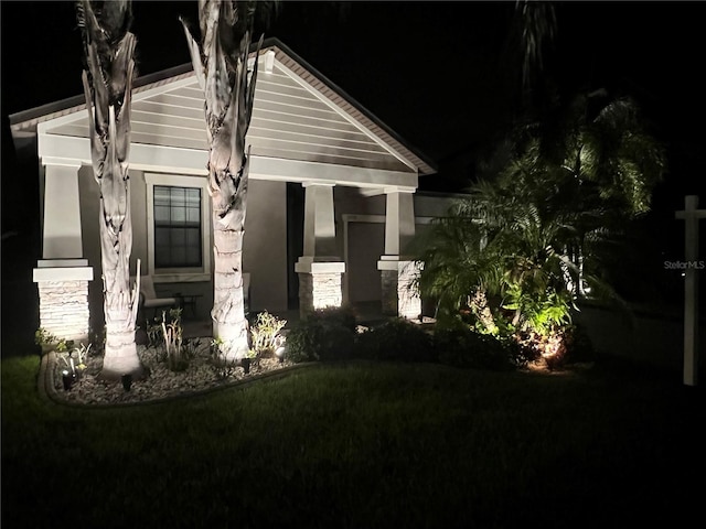 property exterior at twilight featuring stucco siding