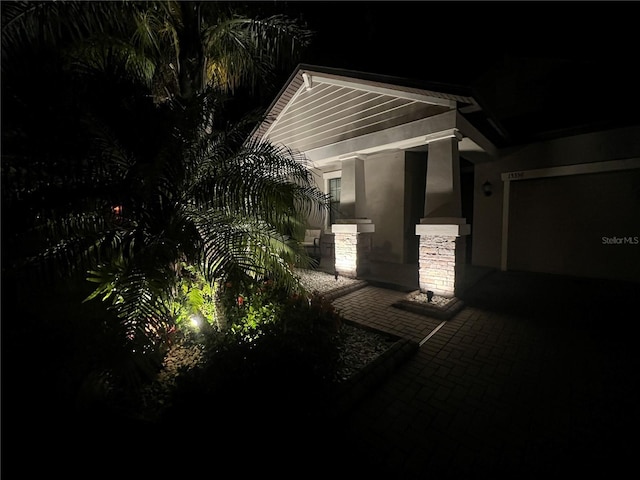 property exterior at twilight featuring stucco siding