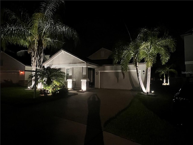 ranch-style house with an attached garage and aphalt driveway