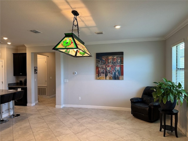 dining room featuring light tile patterned floors, visible vents, and ornamental molding