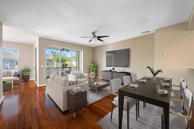 living room with dark hardwood / wood-style flooring, ceiling fan, and a textured ceiling