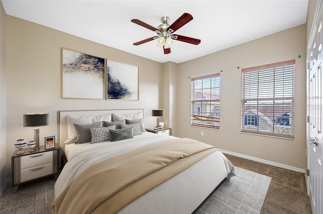 bedroom with ceiling fan and dark colored carpet