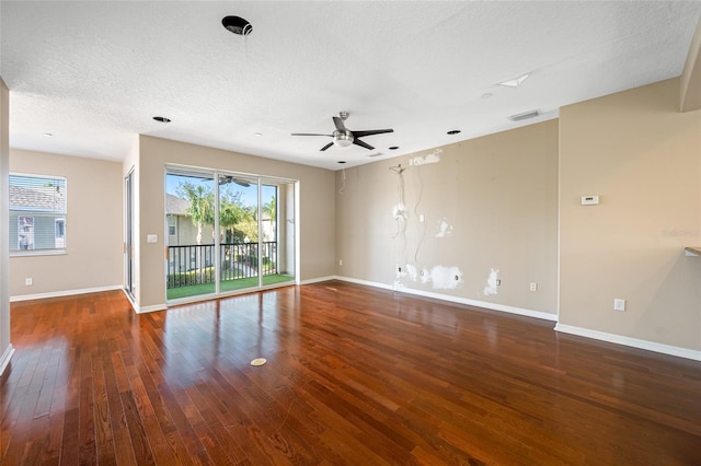 empty room featuring ceiling fan, dark hardwood / wood-style floors, and a textured ceiling