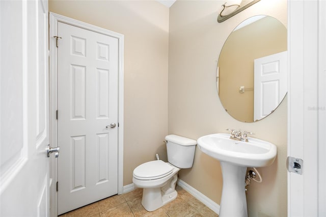 bathroom with sink, tile patterned floors, and toilet