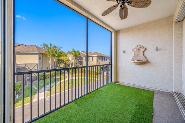 unfurnished sunroom featuring plenty of natural light and ceiling fan