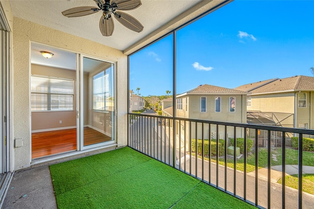 unfurnished sunroom featuring ceiling fan