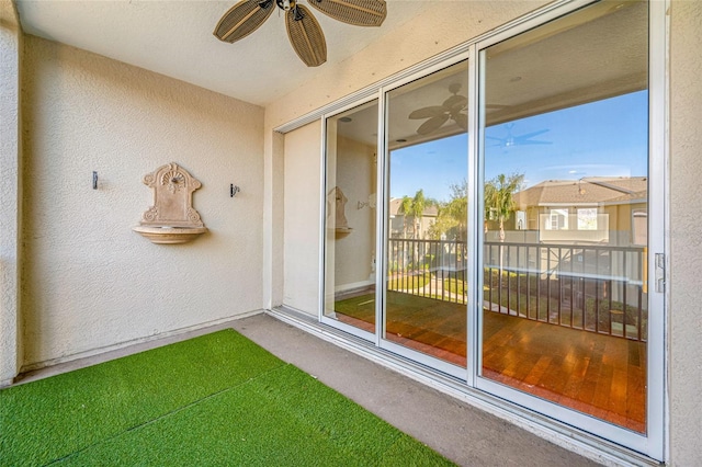 unfurnished sunroom featuring ceiling fan