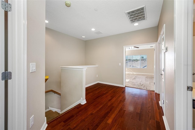 hallway with dark hardwood / wood-style floors