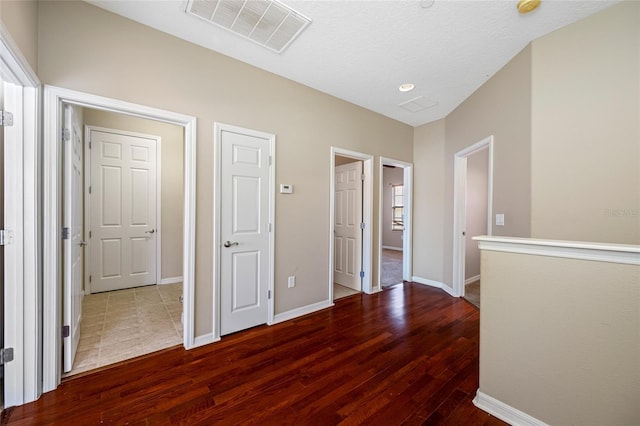 corridor featuring dark hardwood / wood-style flooring