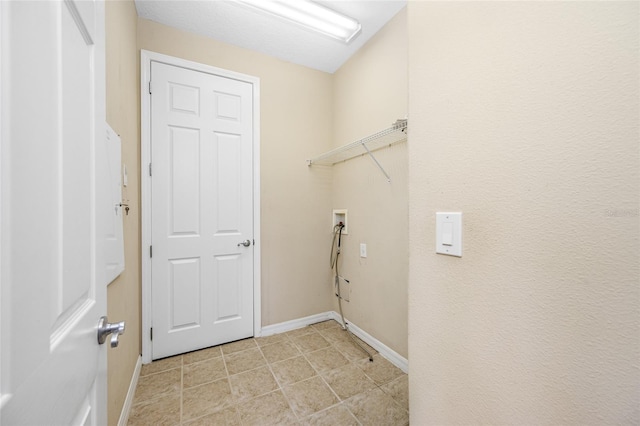 washroom featuring light tile patterned floors and hookup for a washing machine