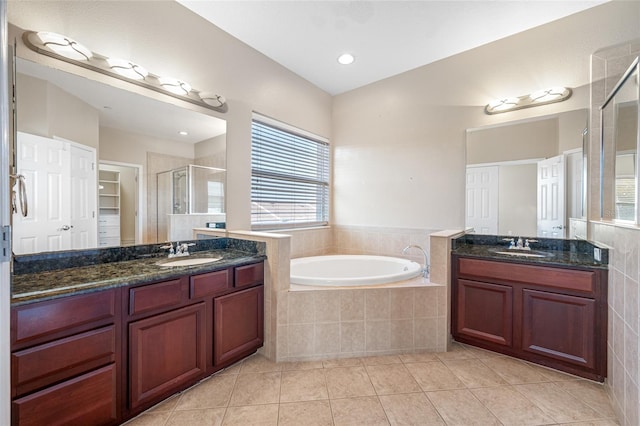 bathroom with plus walk in shower, vanity, and tile patterned floors