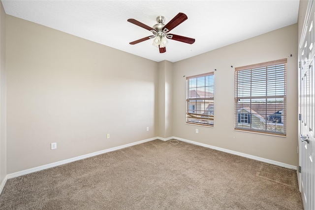 empty room with ceiling fan and carpet flooring