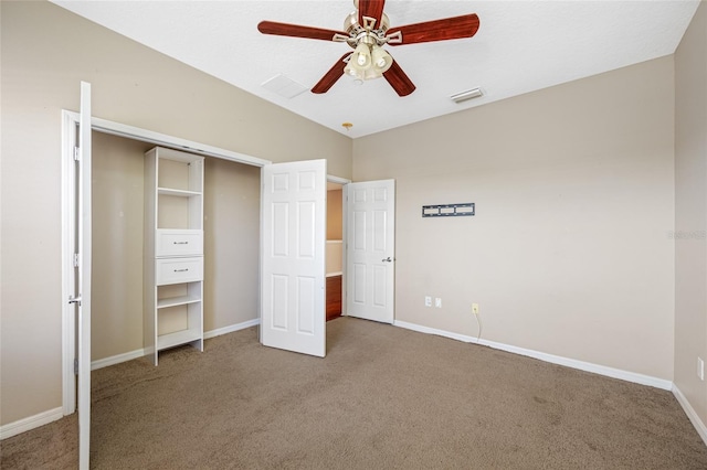 unfurnished bedroom with lofted ceiling, ceiling fan, and carpet