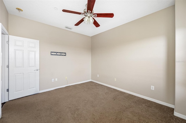 carpeted spare room featuring ceiling fan