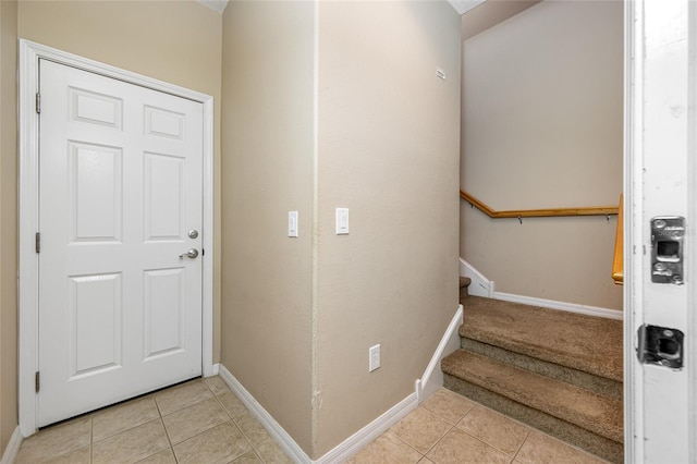 staircase with tile patterned floors