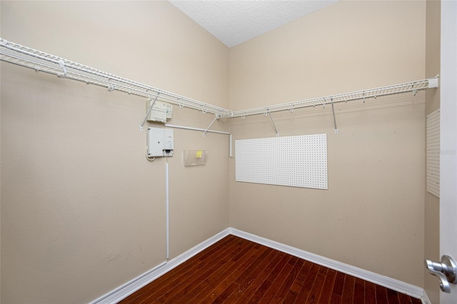 clothes washing area featuring hardwood / wood-style floors and a textured ceiling