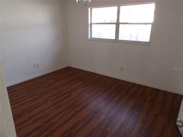 empty room featuring dark wood-type flooring