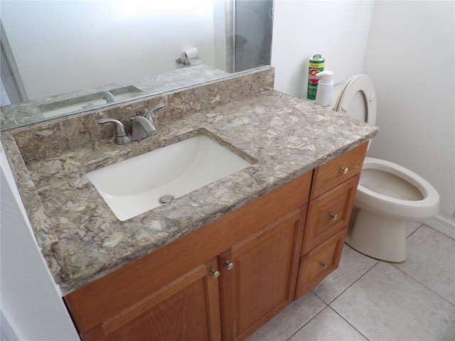 bathroom with vanity, tile patterned floors, and toilet