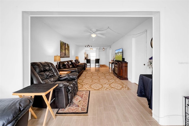 living room with ceiling fan and light hardwood / wood-style floors