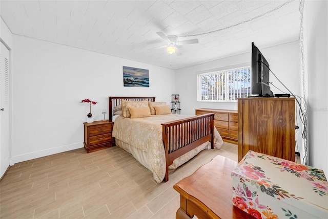 bedroom with ceiling fan and light hardwood / wood-style flooring