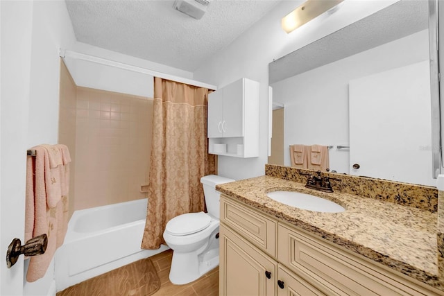 full bathroom with shower / bathtub combination with curtain, vanity, a textured ceiling, and toilet