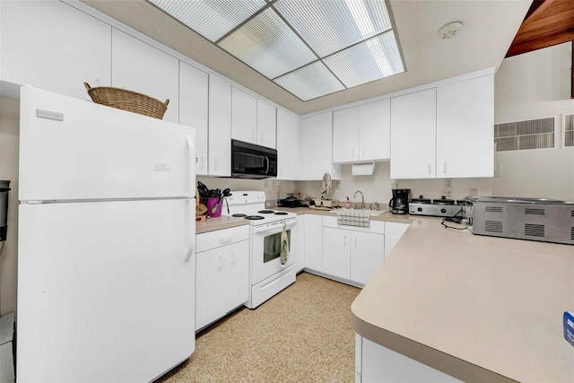 kitchen featuring white cabinetry, white appliances, and sink