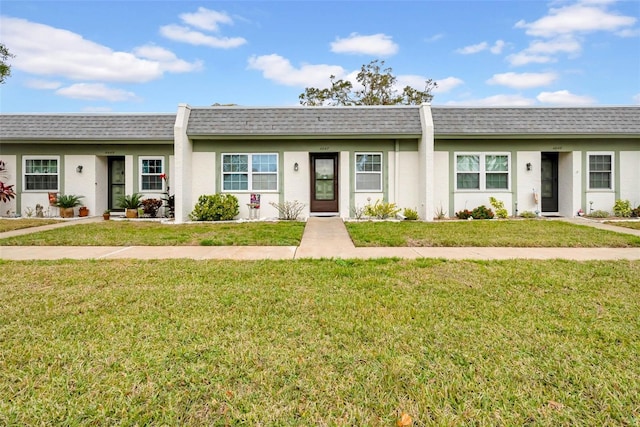 ranch-style home featuring a front yard