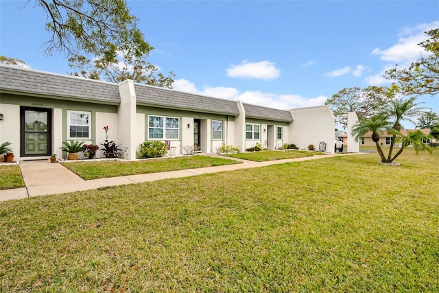 ranch-style home featuring a front yard